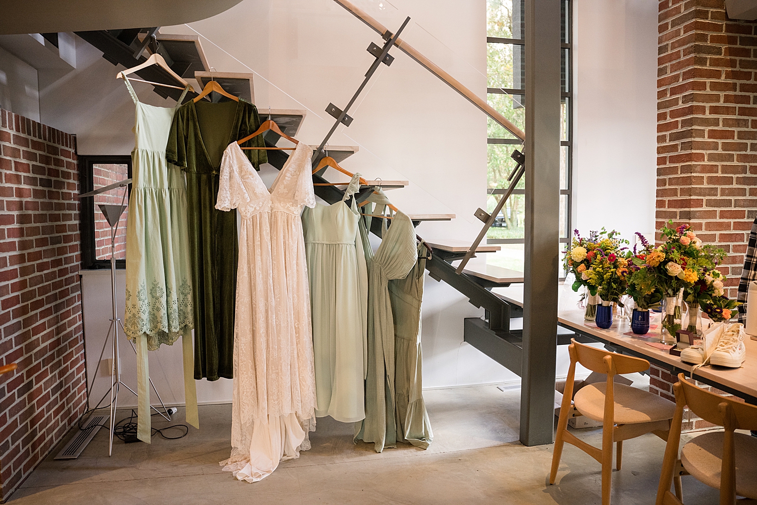 bride and bridesmaid dressing hanging from staircase