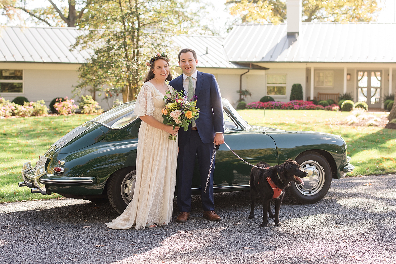 bride and groom portrait with pup in front of vintage car