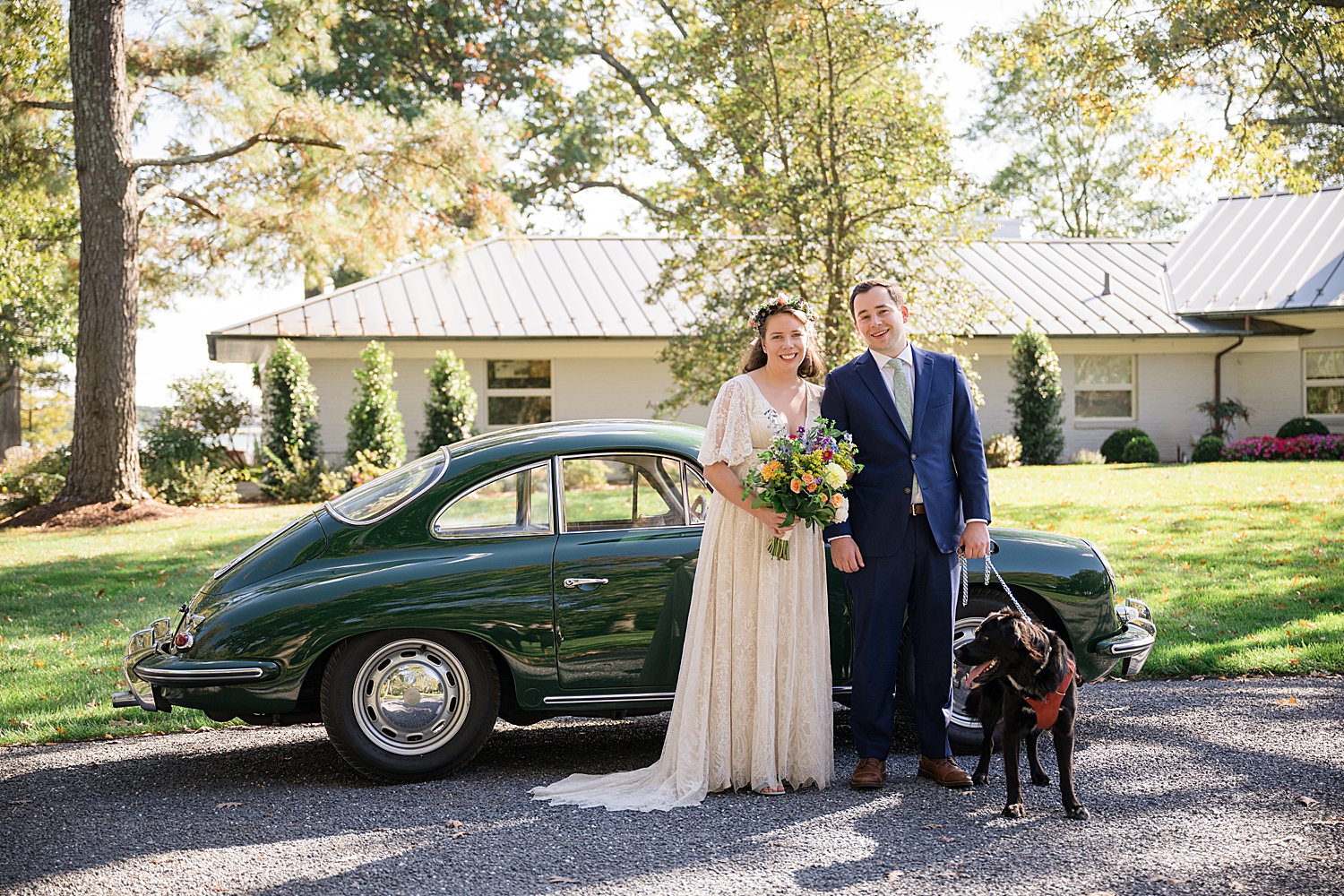 bride and groom portrait with pup in front of vintage car