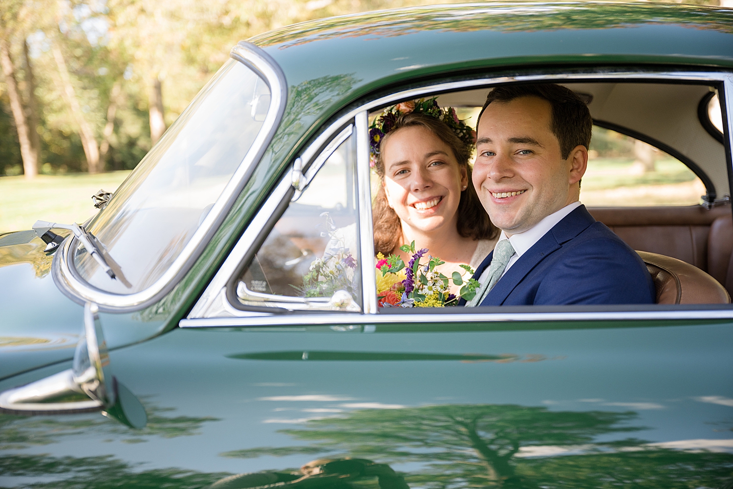 bride and groom portrait in vintage car