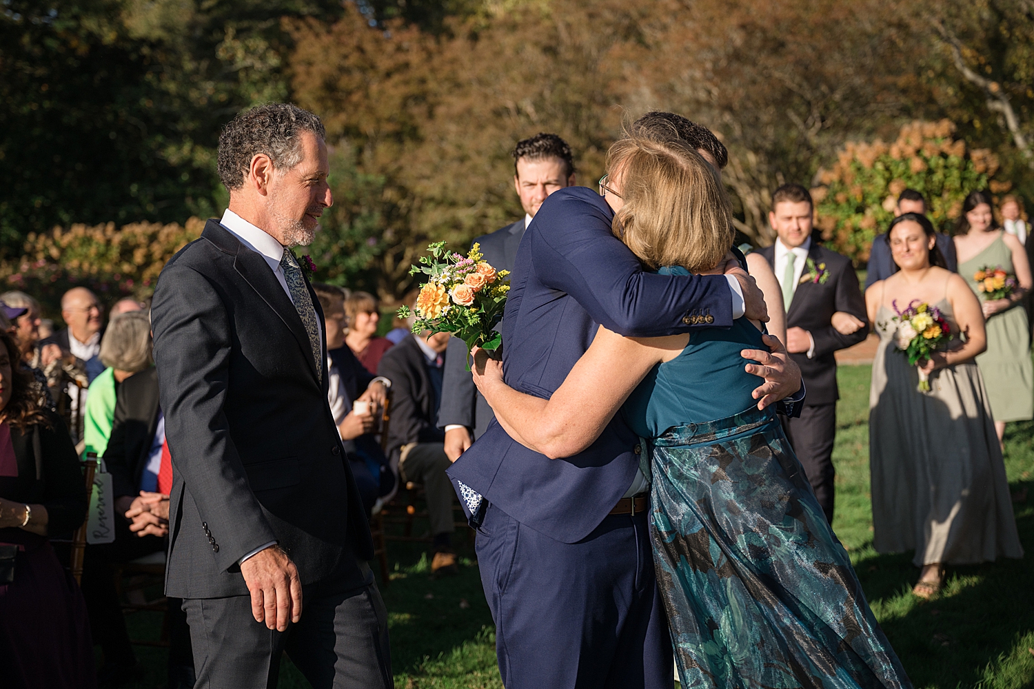 groom hugging parents