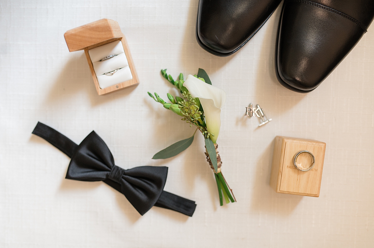 groom details bowtie boutonniere rings