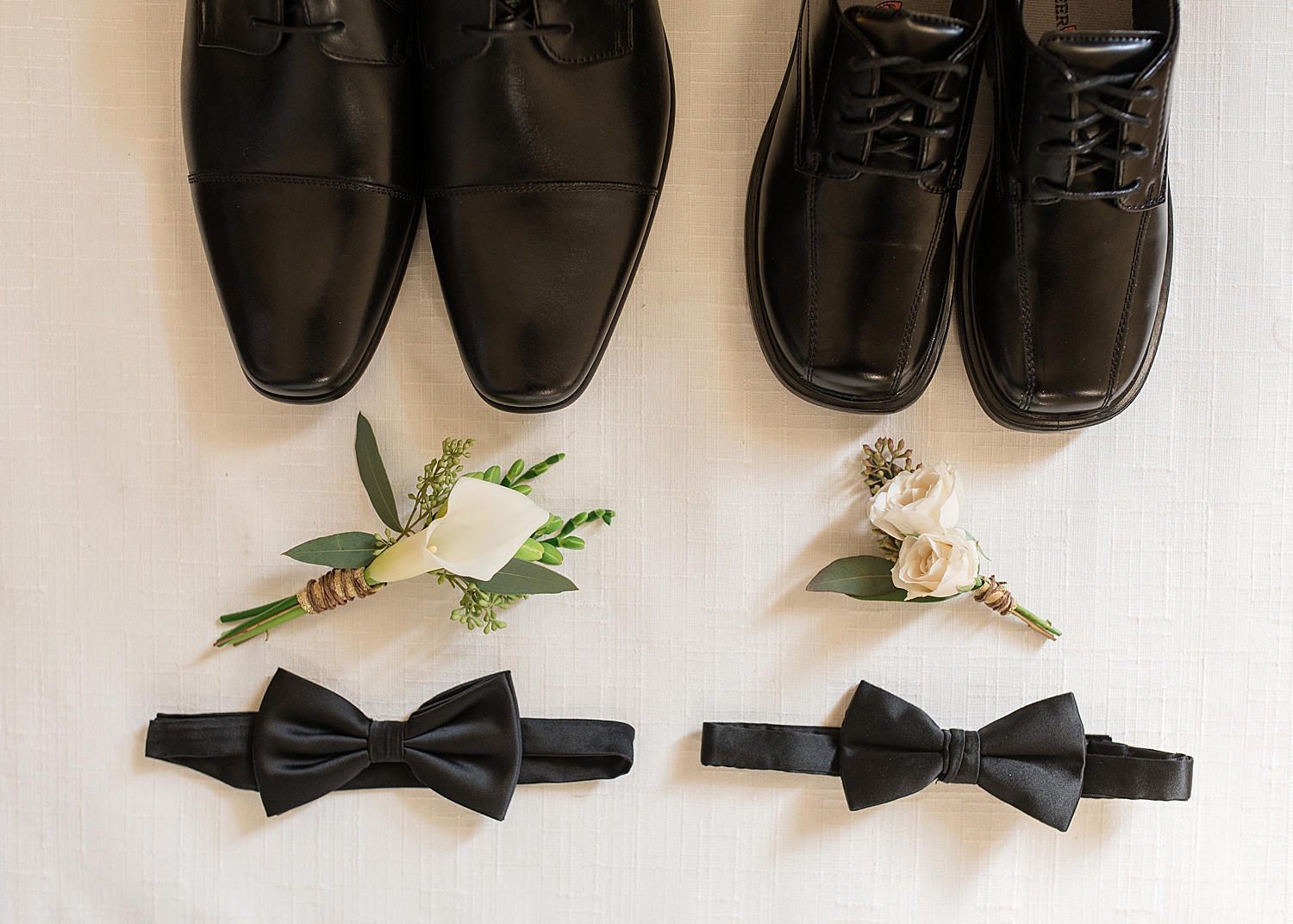 groom and ring bearer details bowtie boutonniere rings