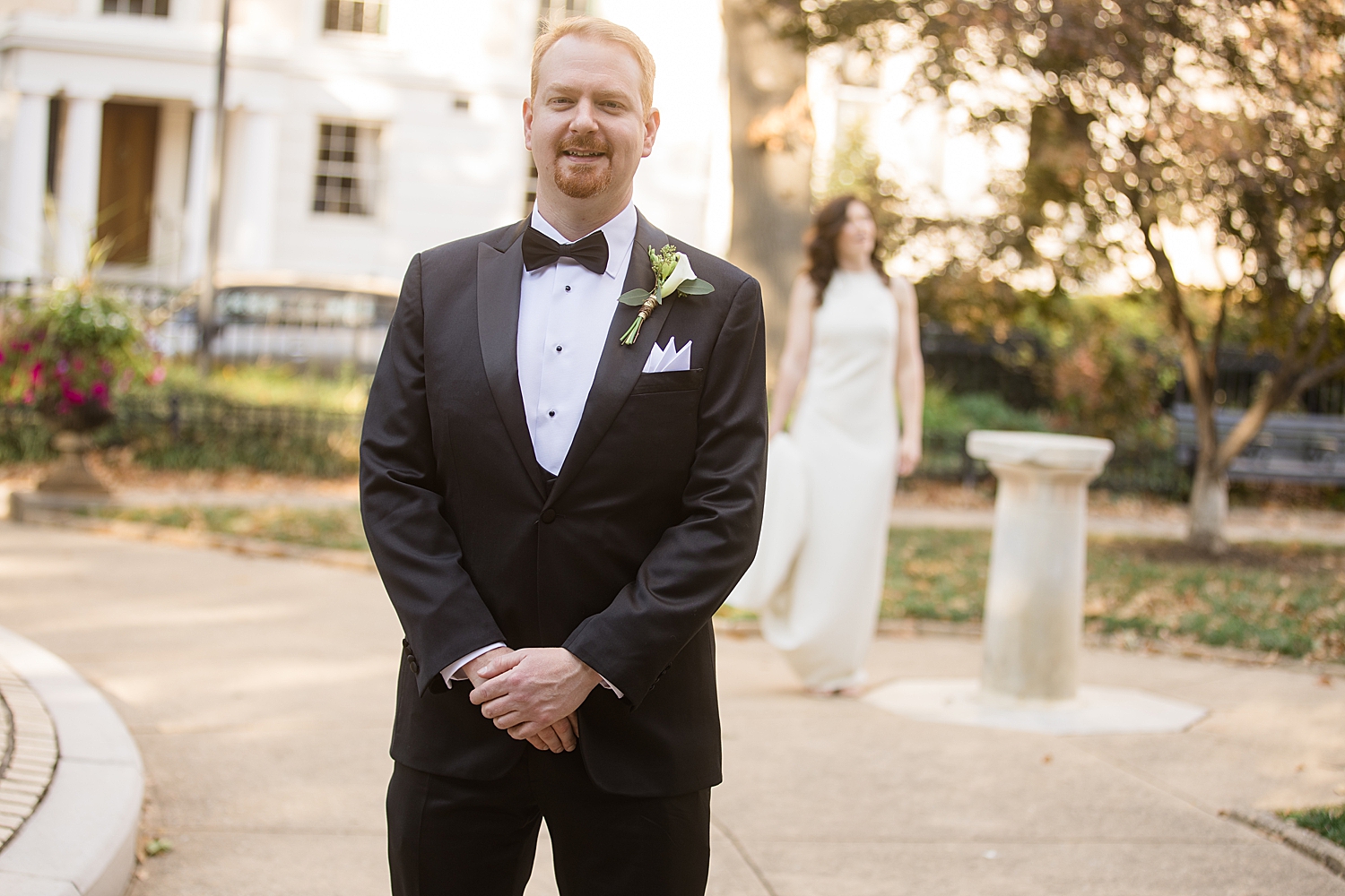 groom portrait as bride approaches for first look