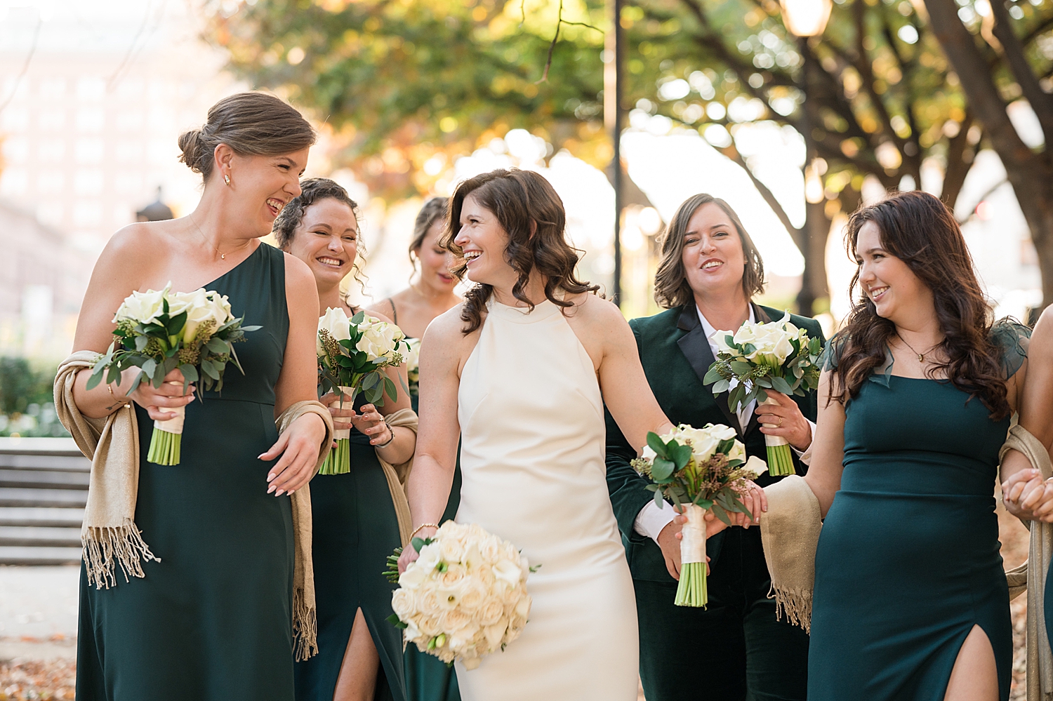 wedding party in black suits and emerald dresses