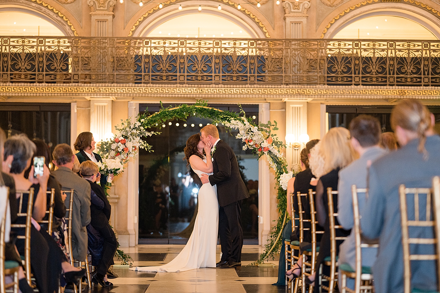 couple's first kiss at wedding ceremony