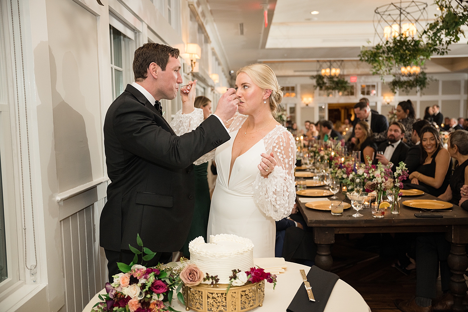 bride and groom cake cutting feeding each other