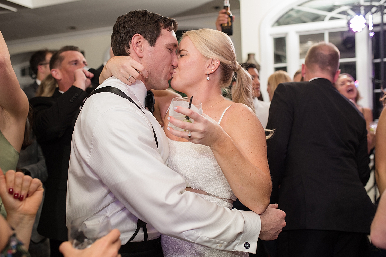 bride and groom kiss on dance floor