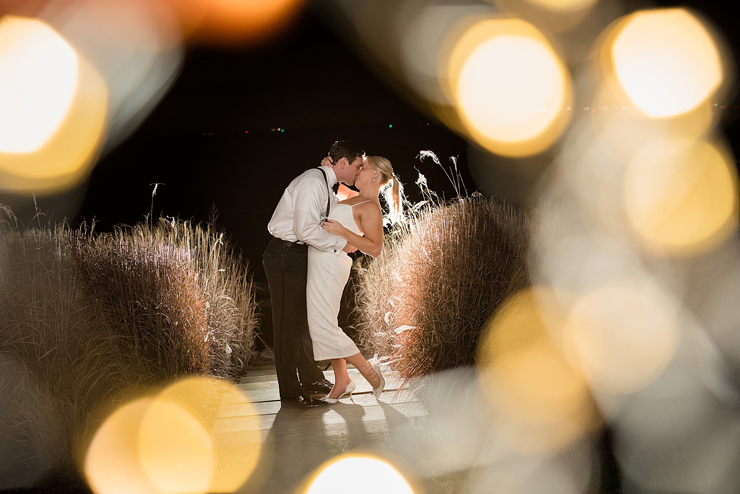 night shot at chesapeake bay beach club, couple surrounded by bokeh