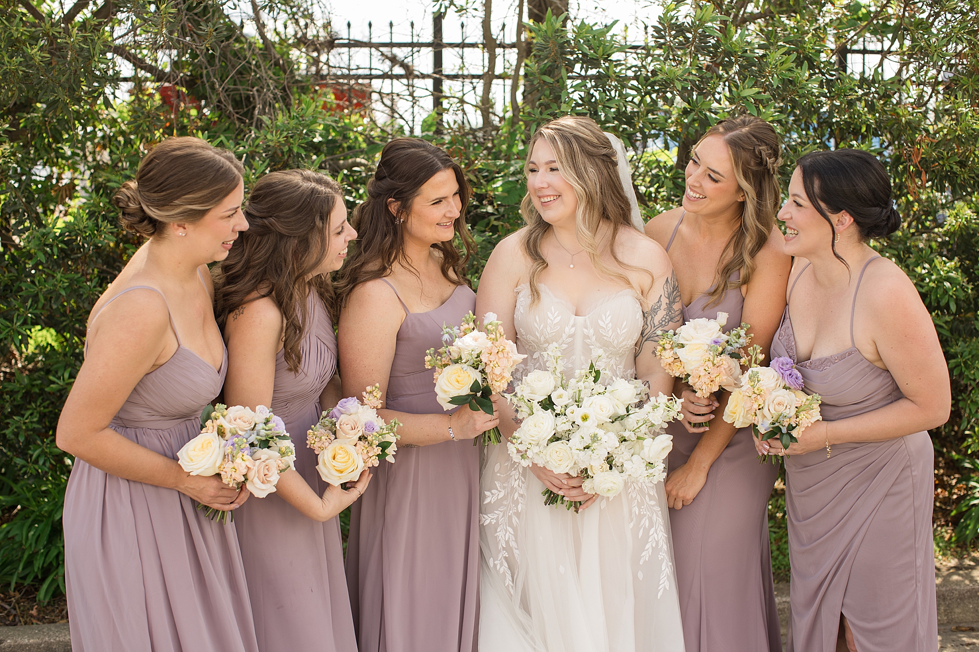 lilac bridesmaid dresses and soft cream blush peach florals